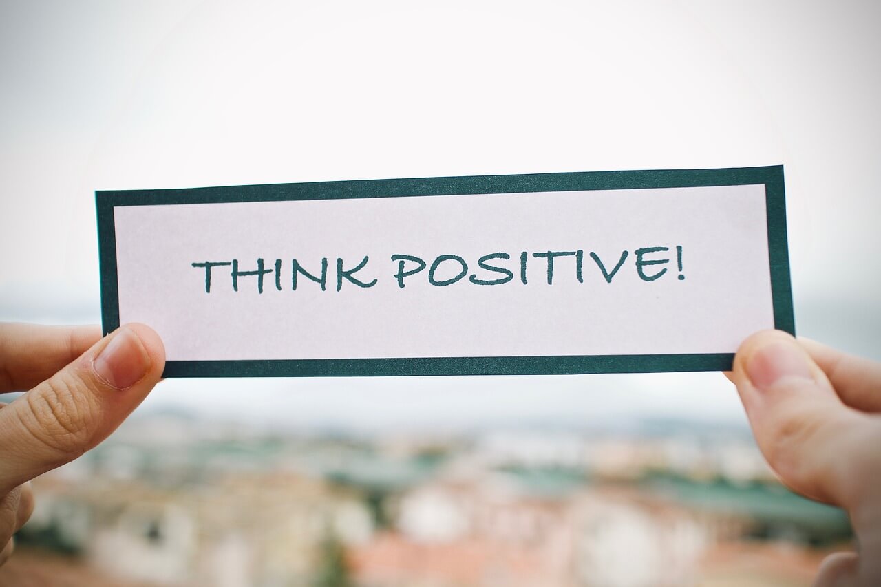 think positive message written on white card